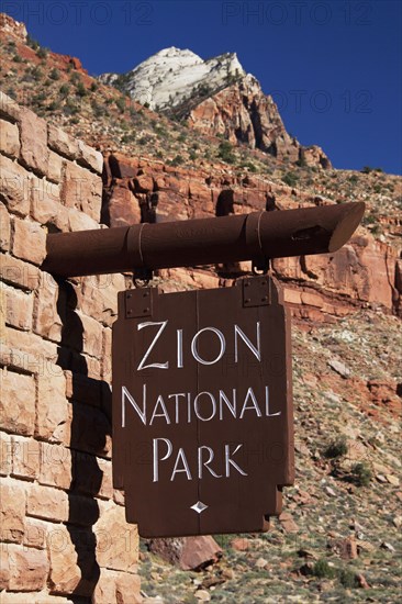 Close up of Zion National Park sign on stone wall