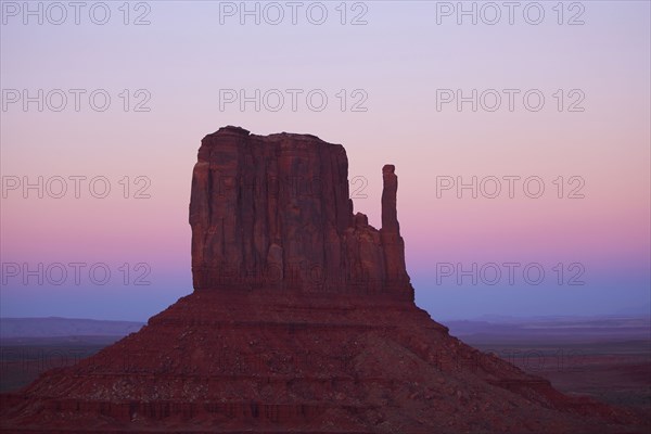 Butte rock formation in desert landscape