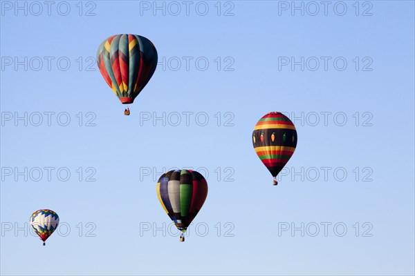 Hot air balloons floating in blue sky