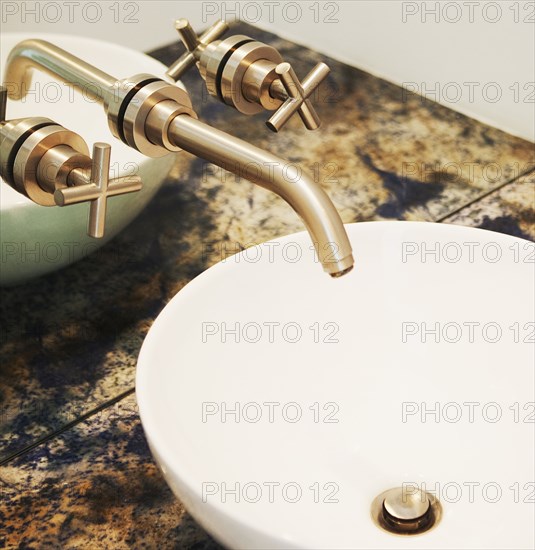 Close up of sink and faucet in modern bathroom