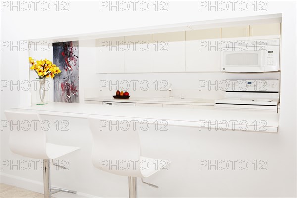 Stools and breakfast bar in modern kitchen