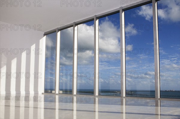 Blue sky viewed through windows in modern apartment