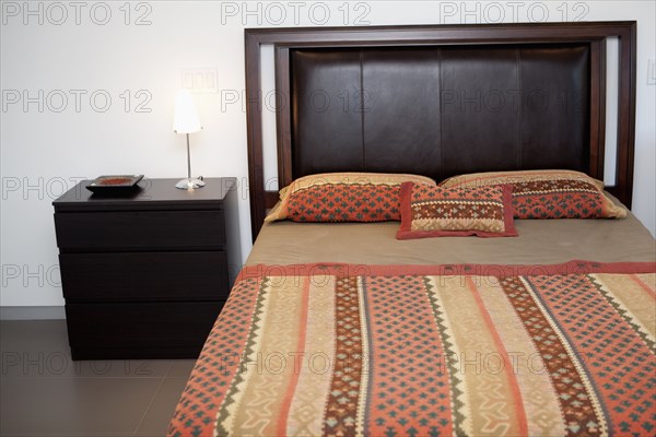 Bed and side table in modern bedroom