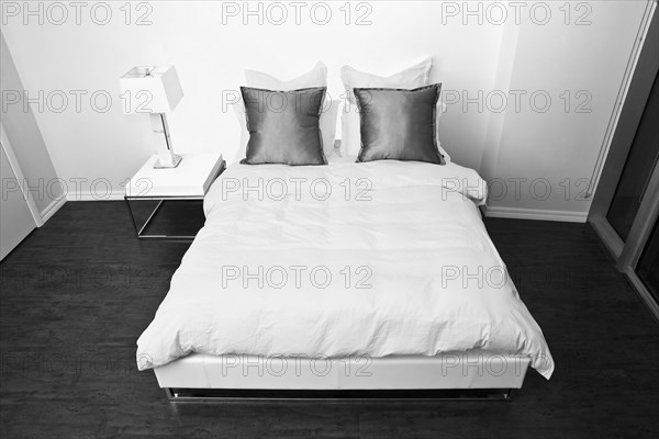 High angle view of bed and night table in modern bedroom