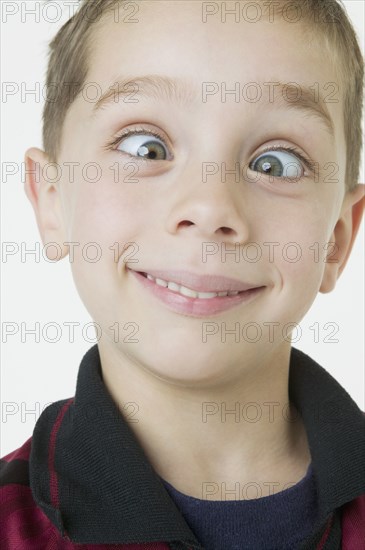 Close up of boy crossing eyes