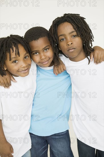 Three African brothers hugging