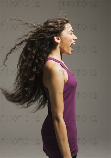 Profile of Asian woman yelling