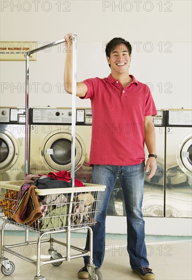 Asian man in laundromat