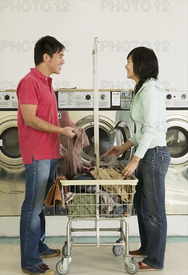 Asian couple in laundromat