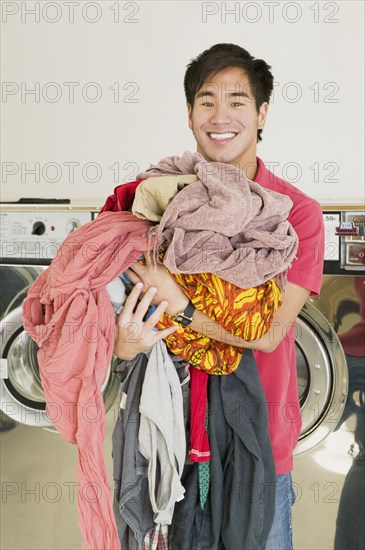 Asian man in laundromat