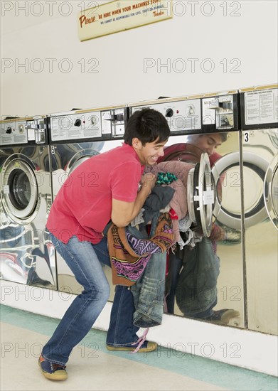 Asian man in laundromat