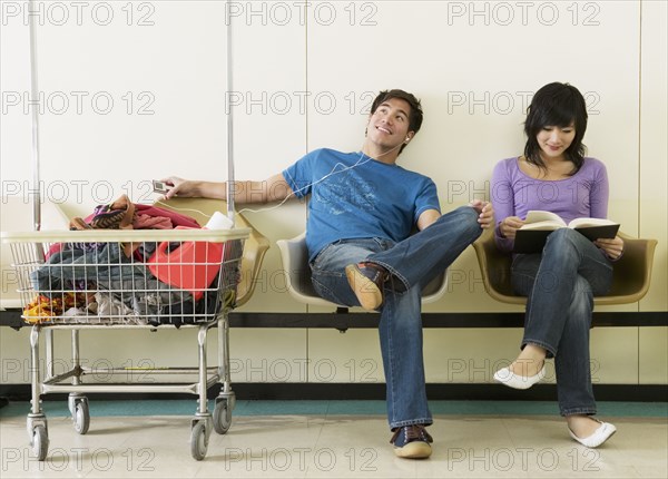 Asian couple in laundromat