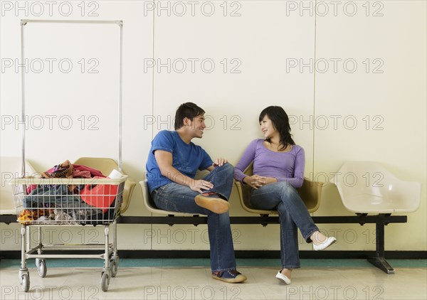 Asian couple in laundromat