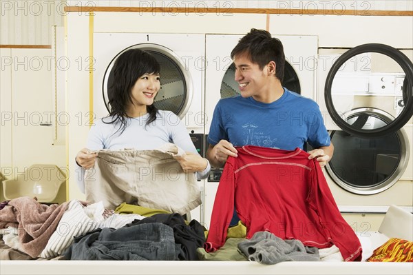 Asian couple in Laundromat