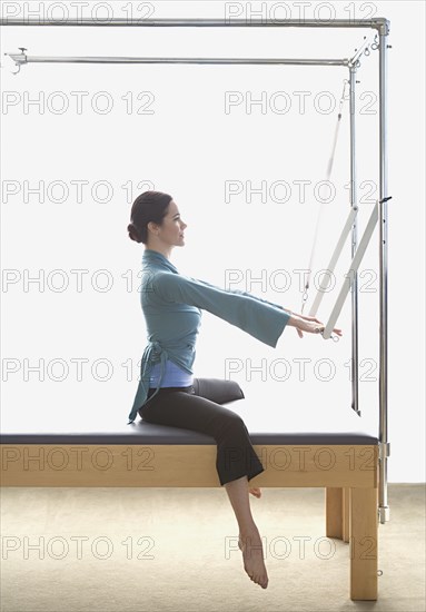 Woman stretching on exercise equipment