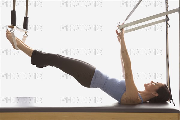 Woman stretching on exercise equipment