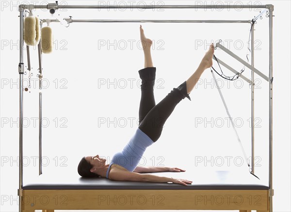 Woman stretching on exercise equipment