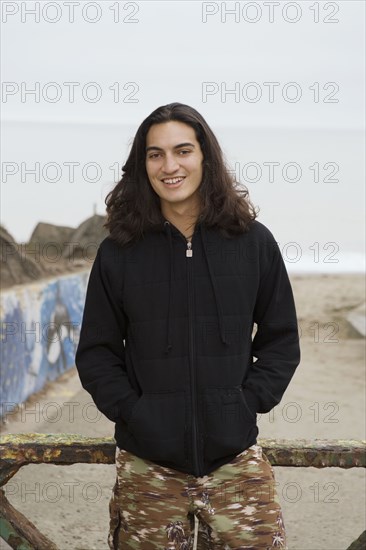 Pacific Islander man with hands in pockets