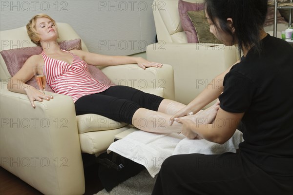 Hispanic woman receiving spa massage