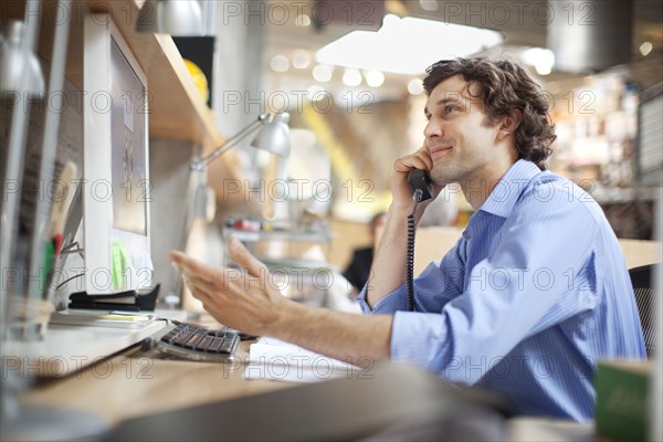 Hispanic businessman talking on telephone