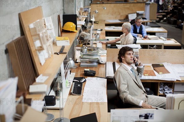 Business people working in busy office