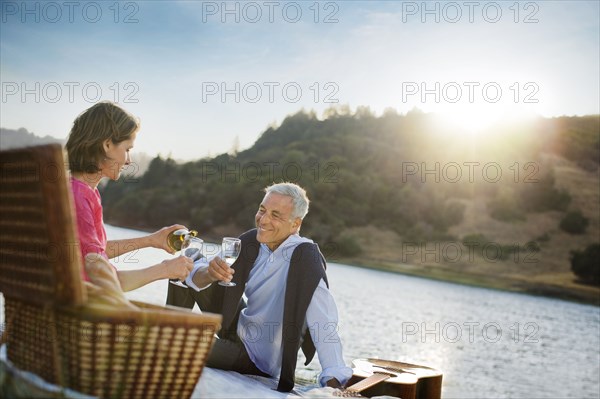 Couple enjoying wine at waterfront