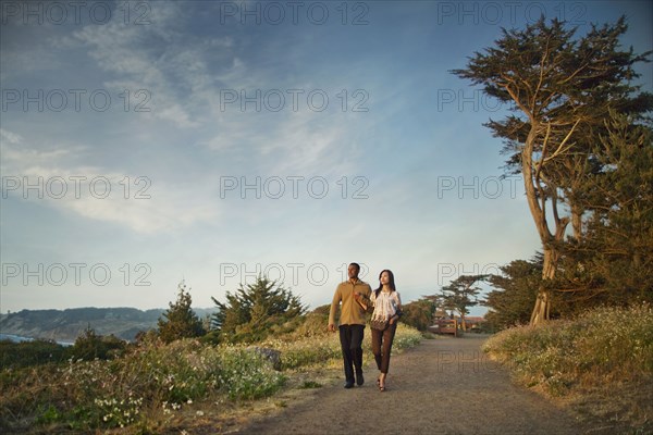 Couple walking on path in park