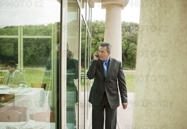 Suspecting Hispanic businessman talking on cell phone