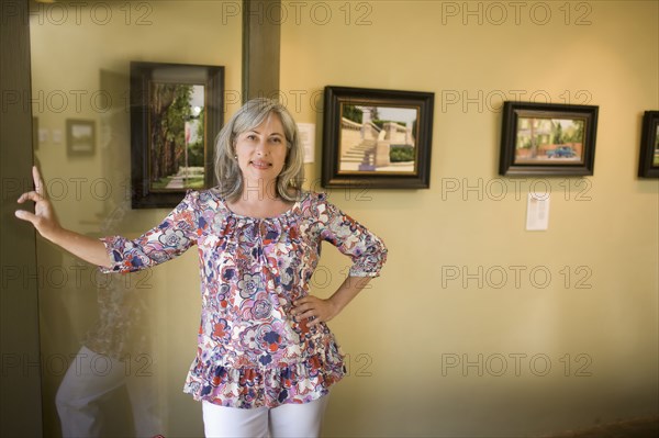 Caucasian woman leaning on doorway