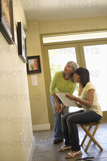 Woman sketching painting in gallery