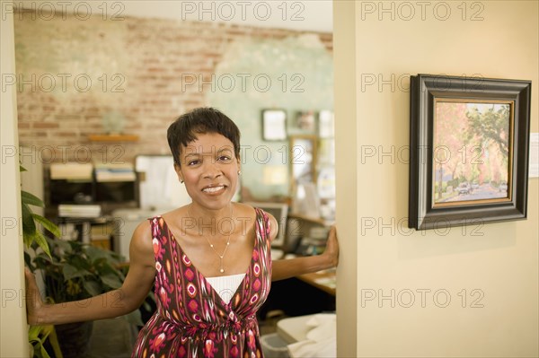 Mixed race woman standing in doorway
