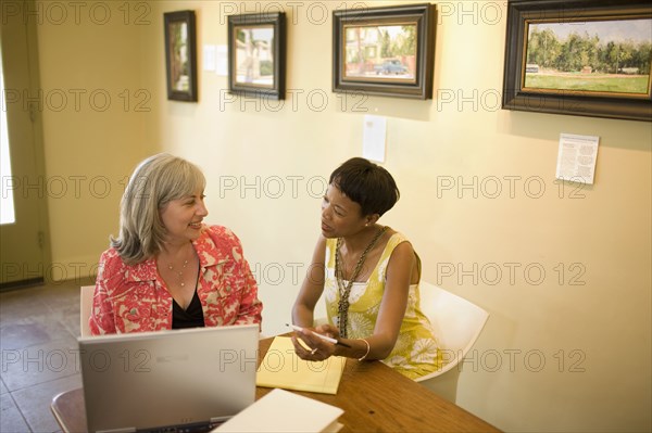 Women in gallery using laptop