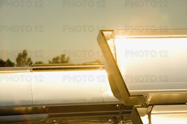 Close up of sun shining on solar panels