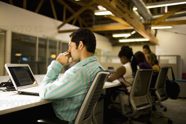 Business people working on communal workspace