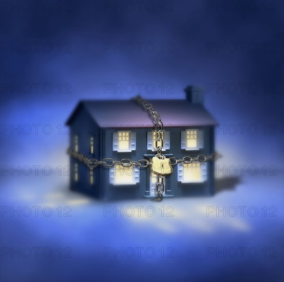 Illuminated house with chain and padlock