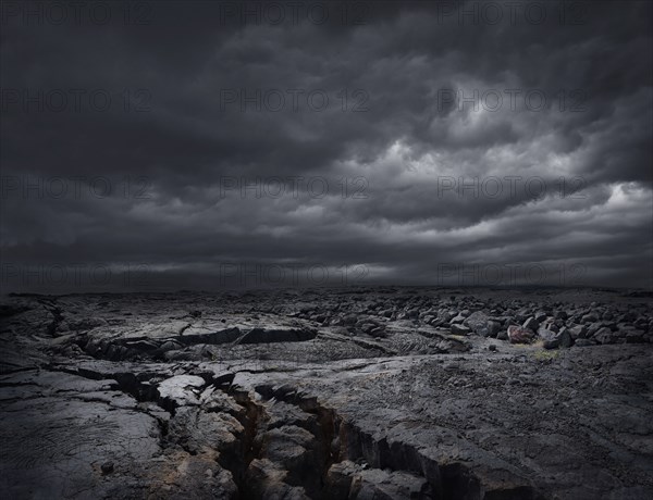 Storm clouds over dry rocky landscape