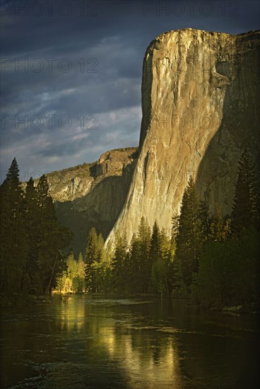 Rock formation reflected in still rural lake