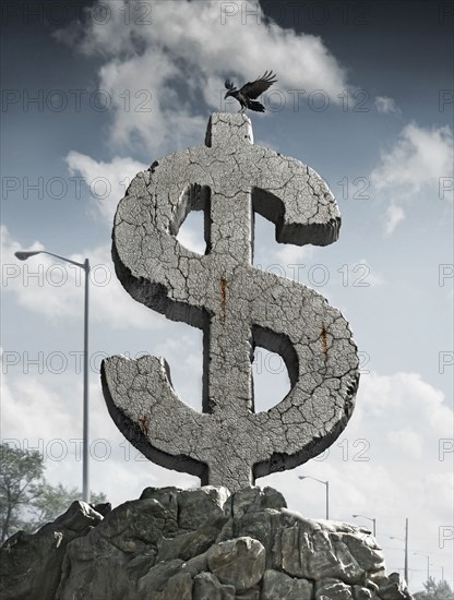 Bird landing on carved stone dollar sign