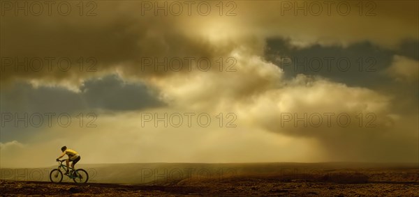 Man riding bicycle on dirt road