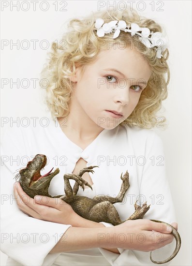 Girl cradling baby dinosaur