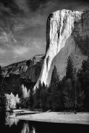 Rock formations over still rural lake