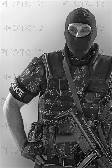 Policeman wearing machine gun and vest