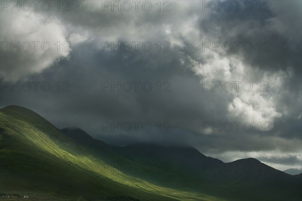 Sun break in clouds in rural landscape