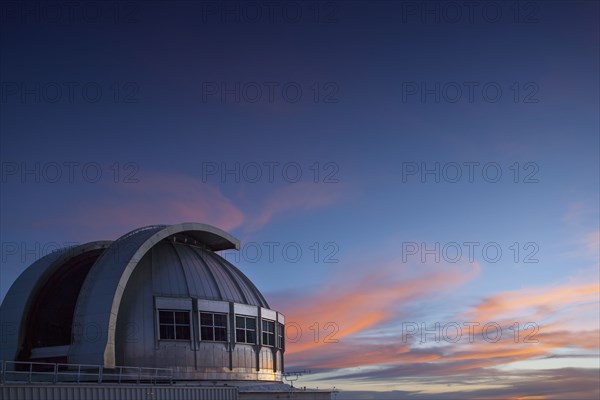 Observatory under colorful sunset sky
