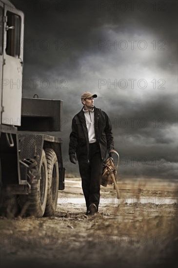 Caucasian farmer walking by truck