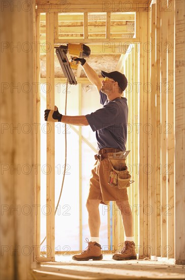 Caucasian carpenter working on building