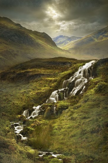 Creek flowing over rocks in rural landscape