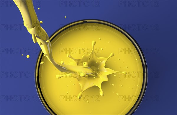 Yellow paint pouring into pot