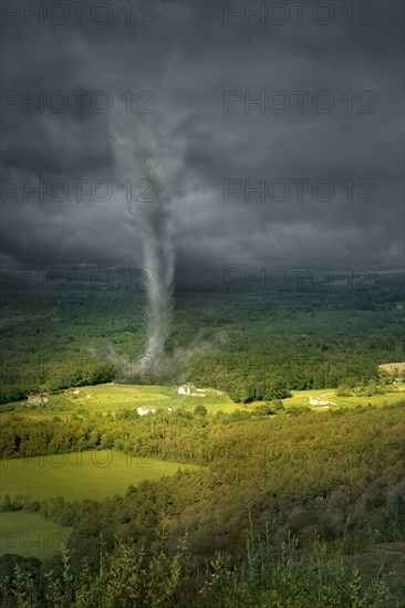 Tornado rolling through rural landscape