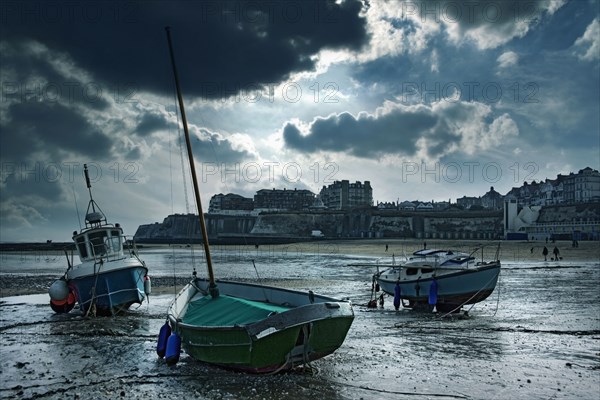 Boats stranded on urban beach